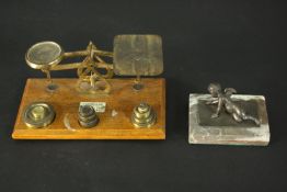 A set of 19th century brass desk scales with maker's label and weights along with a bronze cherub on