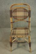A bamboo side chair, with a woven oval panel to the back, and a woven seat, the splayed legs
