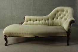 A Victorian mahogany showframe chaise longue, with a buttoned spoon back, upholstered in velour,