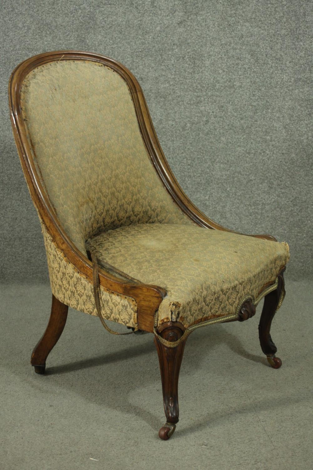 A Victorian walnut nursing chair, upholstered in green fabric, on carved cabriole legs. - Image 2 of 5