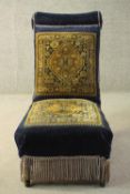 A late Victorian nursing chair, upholstered in blue velour, with sections of a Persian Sarouk rug to