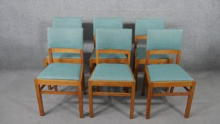 A set of eight Heal's golden oak dining chairs, with two carvers and six side chairs, upholstered in