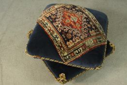 A late Victorian style pouffe, in the form of two stacked cushions, upholstered in blue velour, with