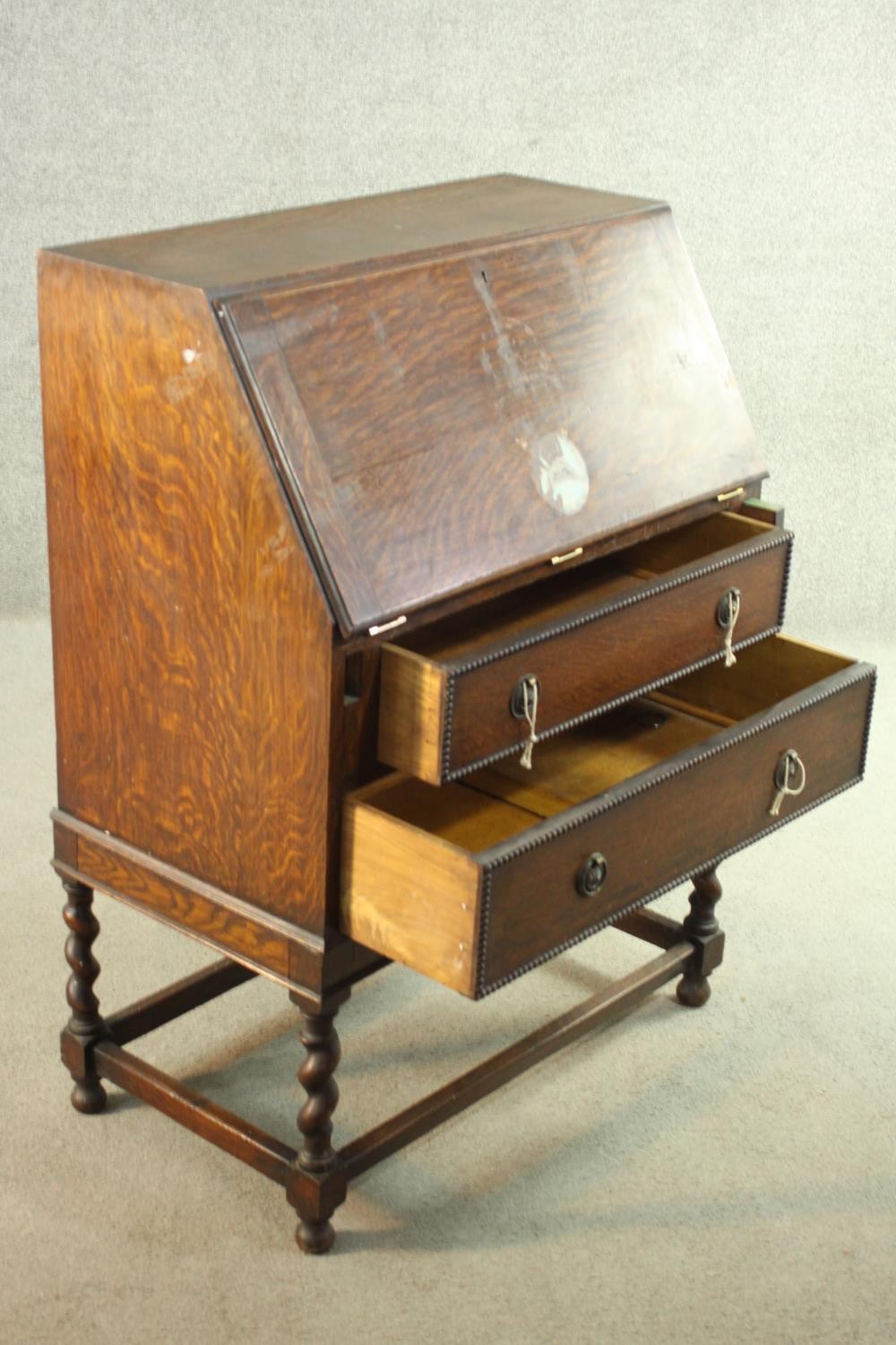 An early 20th century oak bureau, the fall front opening to reveal a fitted interior consisting of - Image 6 of 8