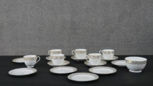 An Adderley gilded floral design fine bone china part six person tea set. Six tea cups and