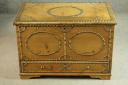 A 19th century pine mule chest, with decorative studded designs, the rising lid revealing a lined