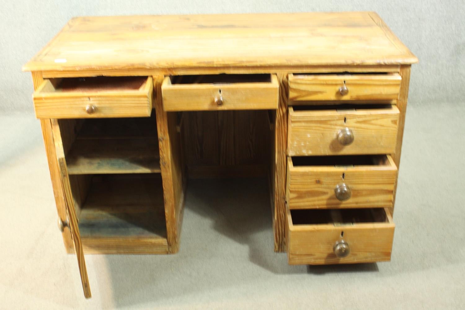 A Victorian pitch pine kneehole desk, with three short drawers, over a cupboard door to one - Image 3 of 8
