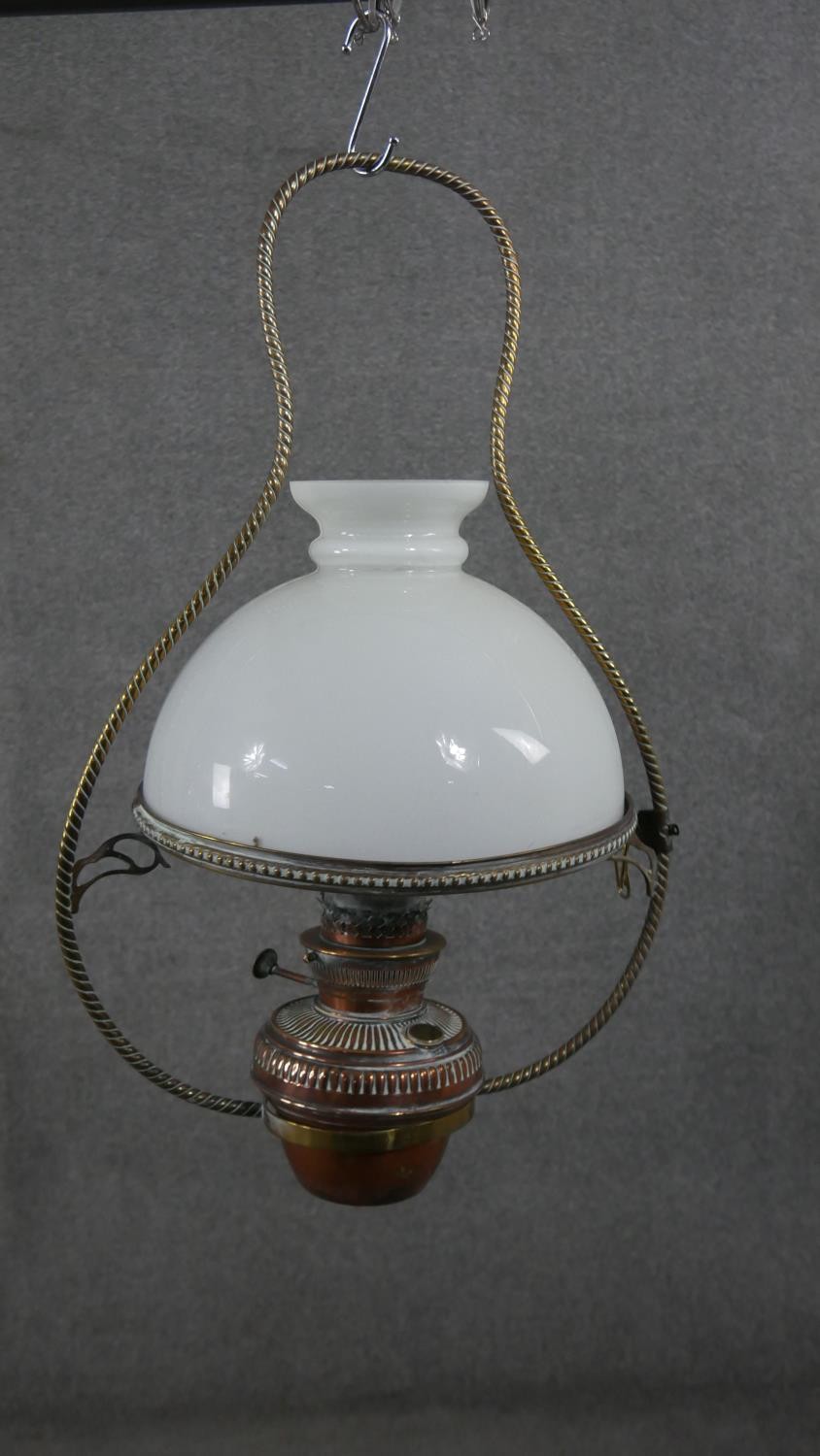 A 19th century hanging oil lamp with milk glass shade and a similar example with copper reservoir.