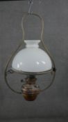 A 19th century hanging oil lamp with milk glass shade and a similar example with copper reservoir.