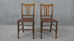 A pair of circa 1900 stained beech side chairs, with brown faux leather seats, on ring turned legs