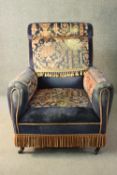 A late Victorian armchair, upholstered in blue velour, with sections of a Persian Mahal rug to the
