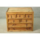 A rustic pine chest of drawers, with a gallery top over two short above two short over two long