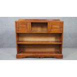 A 20th century cherrywood bookcase, with two cupboard doors centred by a shelf, over two other