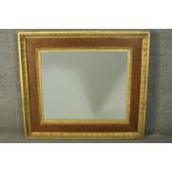 A 19th century oak and parcel gilt framed mirror, with a plain mirror plate, the frame with two