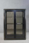 A circa 1970s ebonised and brass display cabinet, with two glazed doors, glazed sides and back,