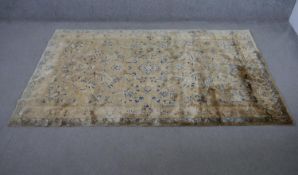 An Isphahan design rug with all over scrolling foliate motifs on a biscuit ground within floral