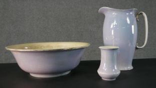 A Regal Ware pottery wash basin, jug, and vase, with a lilac glaze and a gilded handle, marked to