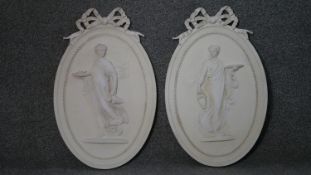 A pair of plaster relief wall plaques with classical style figural decoration. H.53 W.34cm