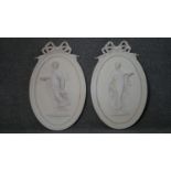 A pair of plaster relief wall plaques with classical style figural decoration. H.53 W.34cm