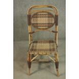 A bamboo side chair, with a woven oval panel to the back, and a woven seat, the splayed legs