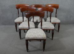 A set of six mahogany dining chairs, circa 1840, with bar backs, on carved reeded supports, over