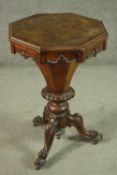 A Victorian figured walnut trumpet form sewing table, with an octagonal lid, rising to reveal a blue