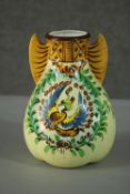 A Japanese hand painted porcelain gourd form vase decorated with a phoenix among foliage, wing