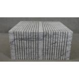 A contemporary white marble coffee table, the exterior cut with 'vertical' lines, the interior