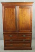 A Victorian walnut linen press, with two cupboard doors enclosing linen slides, over two short and