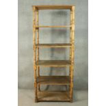 A Victorian style pine whatnot, of six tiers with turned baluster supports. H.216 W.84 D.50cm.