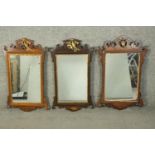 Three George III design mahogany and parcel gilt fretwork mirrors, each with a carved and gilt ho-ho