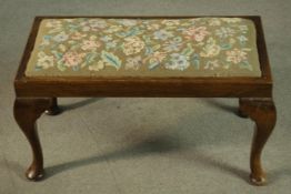 A Georgian style oak stool, early 20th century, the drop-in seat upholstered in foliate tapestry, on