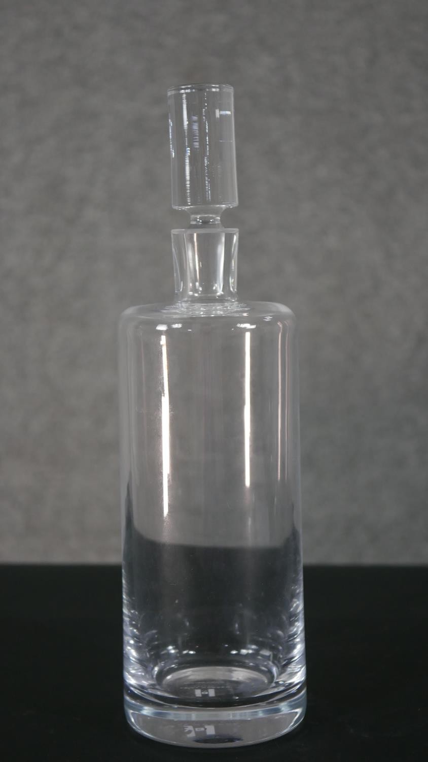 A Kelly Hoppen crystal cylindrical decanter with stopper. Label to base. H.31 Diam.9cm