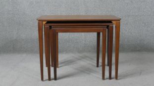 A circa 1960s teak next of three tables, the rectangular tops on tapering square section legs. H.