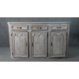 A 19th century French provincial painted oak buffet, grey painted and distressed, the rectangular