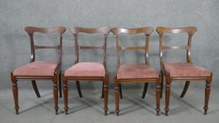 A set of four Victorian mahogany bar back dining chairs, with pink velour drop in seats, on turned