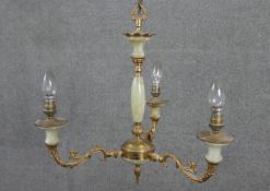 A brass and onyx three branch chandelier, the cast branches of S scrolling form. H.47 W.47cm