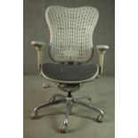 A Formway style office chair, in grey, with a pierced back, and adjustable arms, on a five point