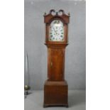 A George III oak cased longcase clock, the hood with a swan neck pediment and brass orbs, the