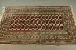 A Pakistan Bokhara rug with elephant's foot motif within multiple borders. L.194 W.134cm.