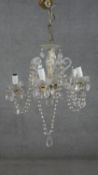 A large cut crystal and cane glass five branch chandelier with hanging crystal drops and swags. H.55