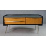 A circa 1950s black lacquered and birch sideboard, with a rectangular top over two drawers and a