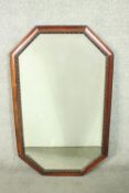 An early 20th century mahogany framed mirror, of rectangular form with canted corners, with a