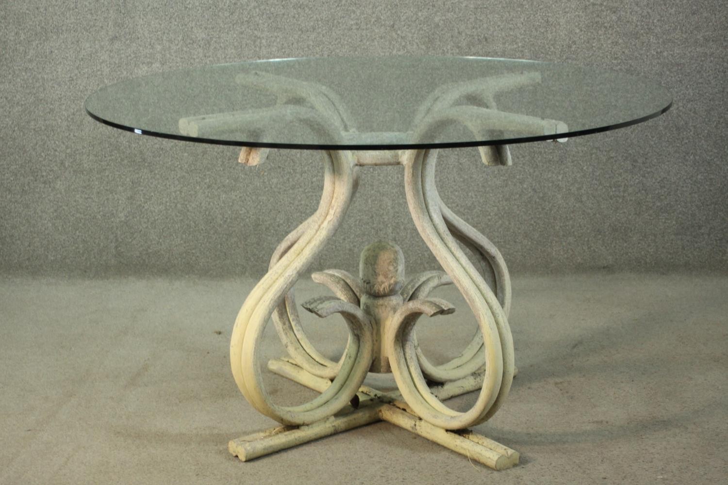 A Thonet style bentwood dining table, with a circular plate glass top, on a white painted bentwood