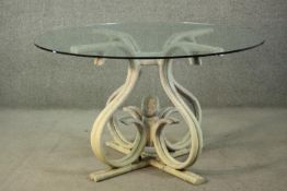 A Thonet style bentwood dining table, with a circular plate glass top, on a white painted bentwood
