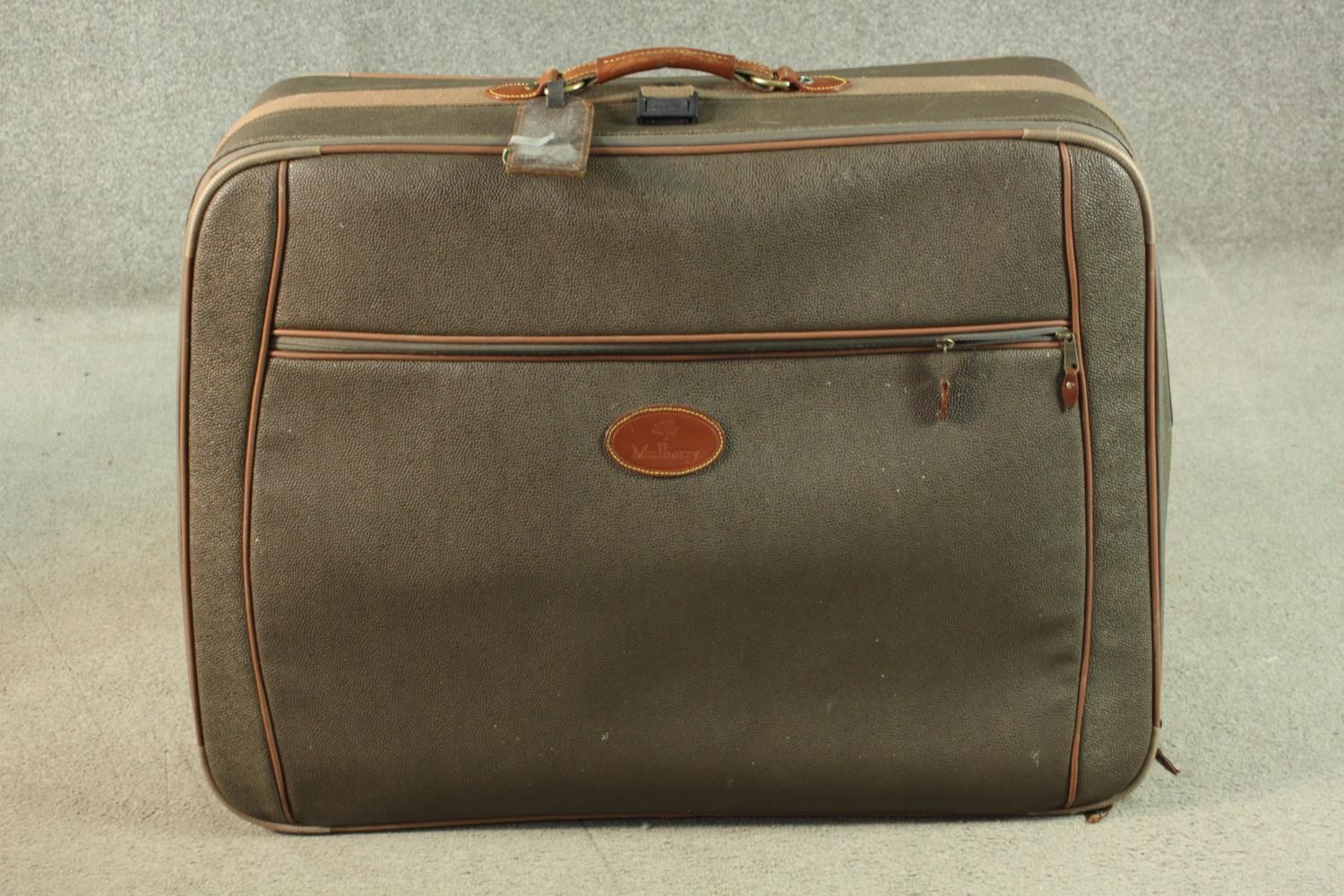 A Mulberry scotchgrain leather travelling case with wheels and spring loaded extending handle,