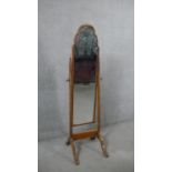 A circa 1920's George III style cheval mirror, the slender mirror plate with a cloud top, the