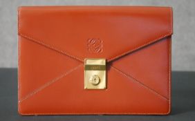 A Loewe clutch handbag in light tan leather with Loewe dustbag. H.18 W.26cm