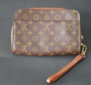 A small Louis Vuitton handbag with strap, marked Louis Vuitton Paris. H.17 W.24cm