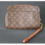 A small Louis Vuitton handbag with strap, marked Louis Vuitton Paris. H.17 W.24cm